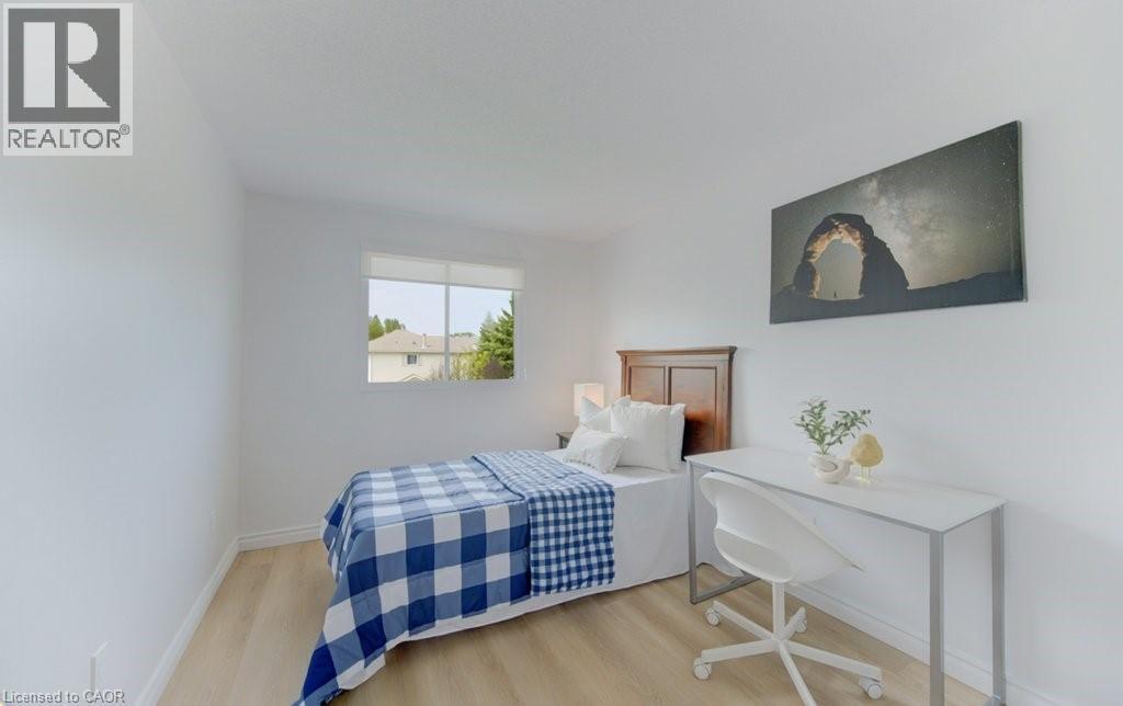 Bright room featuring light wood-finish flooring and white baseboards - 603 Pinerow Crescent Unit# B, Waterloo, ON - Indoor Photo Showing Bedroom