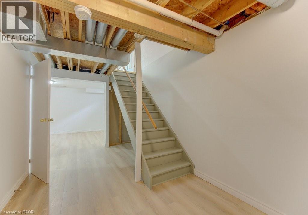 Unfinished basement space featuring exposed wooden joists and ductwork - 603 Pinerow Crescent Unit# B, Waterloo, ON - Indoor