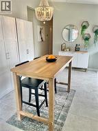 Wood-finish high-top table with light-toned tiled flooring -