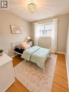 Room featuring wood-finish flooring and a beaded chandelier -