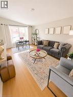 Open-concept living space with light wood-finish flooring -