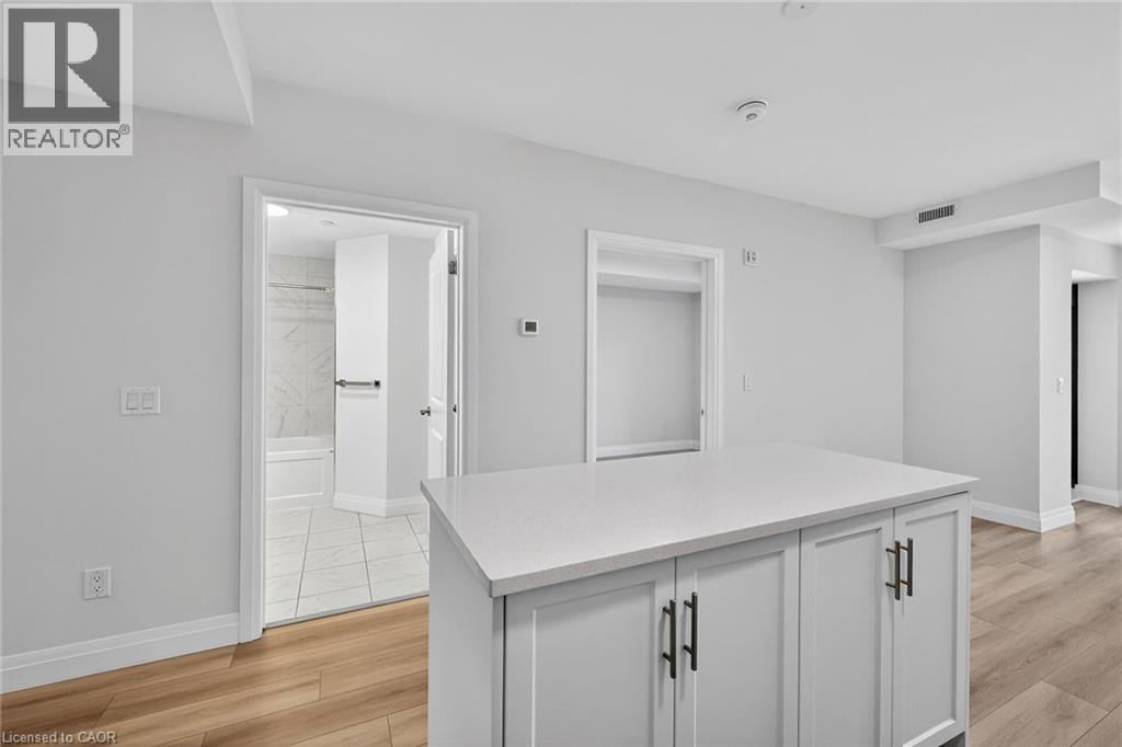 Island With Breakfast Bar - 153 Wilson Street W Unit# 310, Ancaster, ON - Indoor Photo Showing Other Room