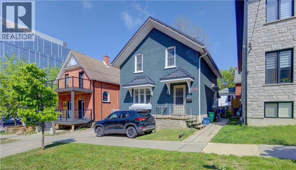 Two-story residence with steel roof, white trim windows, and a covered entry - 48 Breithaupt Street, Kitchener, ON - Outdoor With Facade