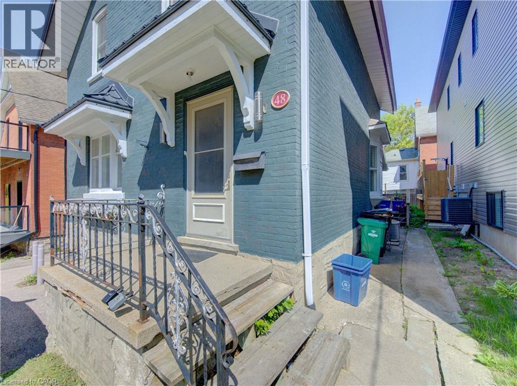 Front entrance to upper and main level units featuring a decorative iron railing, and a covered entry - 48 Breithaupt Street, Kitchener, ON - Outdoor