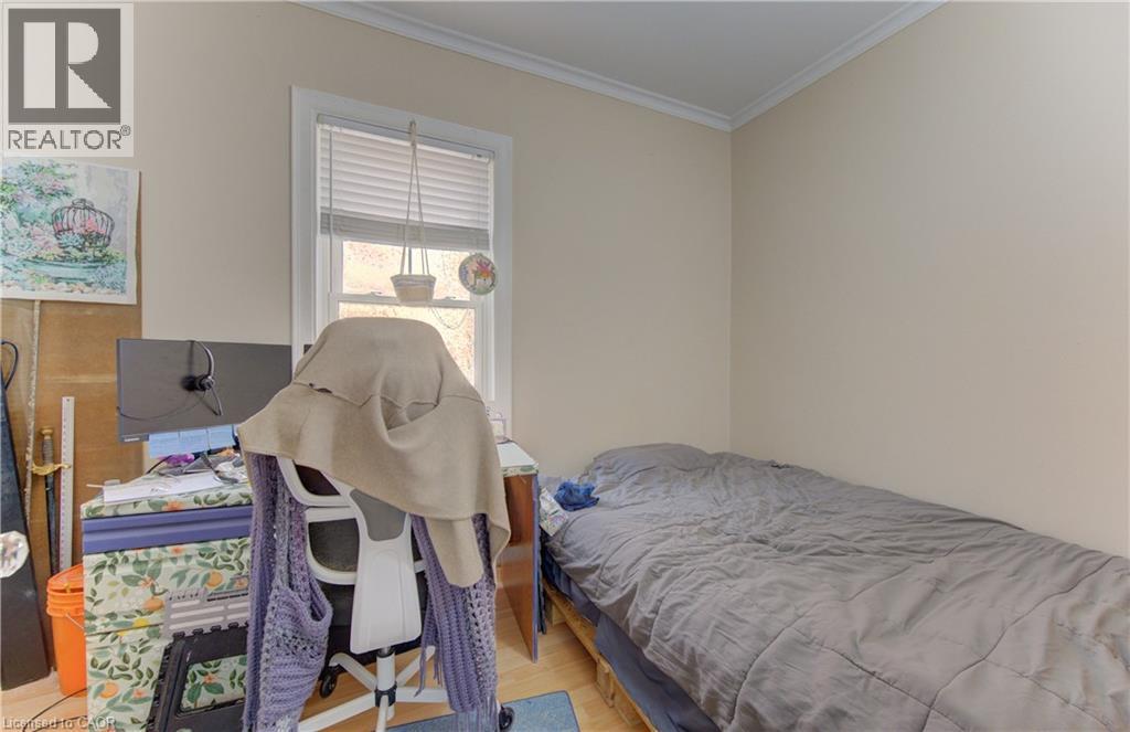 Room featuring light-toned walls, crown molding, and wood-finish flooring - 48 Breithaupt Street, Kitchener, ON - Indoor Photo Showing Bedroom