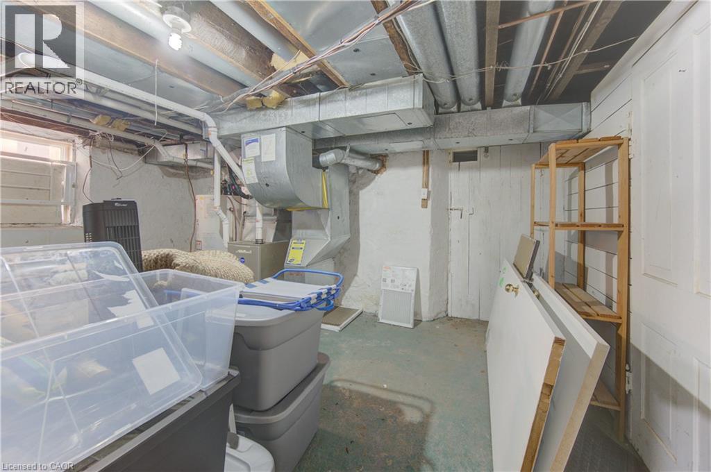 Basement utility space featuring exposed ceiling joists, white painted walls, and a visible HVAC system - 48 Breithaupt Street, Kitchener, ON - Indoor Photo Showing Basement