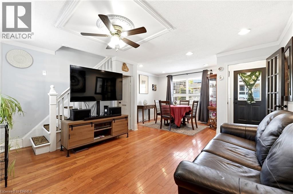 Hardwood flooring spans this open concept living area - 23 Britannia Avenue, Hamilton, ON - Indoor Photo Showing Living Room