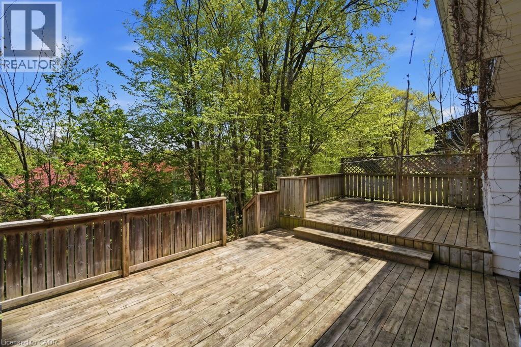 Multi-level wooden deck featuring slat railings and a lattice privacy screen - 46 Birchcliff Avenue, Kitchener, ON - Outdoor With Deck Patio Veranda