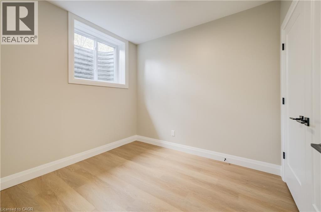 Room featuring light wood-finish flooring, neutral painted walls, and white baseboards - 210 Heritage Drive Unit# Main, Kitchener, ON - Indoor Photo Showing Other Room