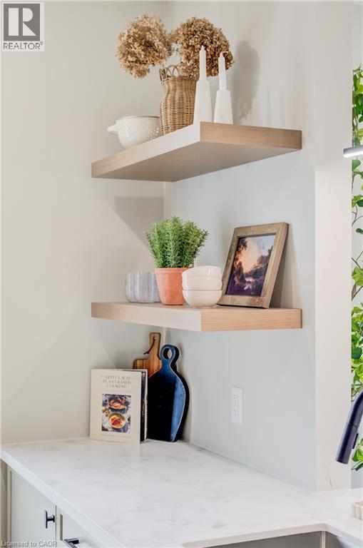 Floating wood-finish shelving above a light-toned countertop, featuring a recessed sink basin and a matte black faucet - 210 Heritage Drive Unit# Main, Kitchener, ON - Indoor Photo Showing Other Room