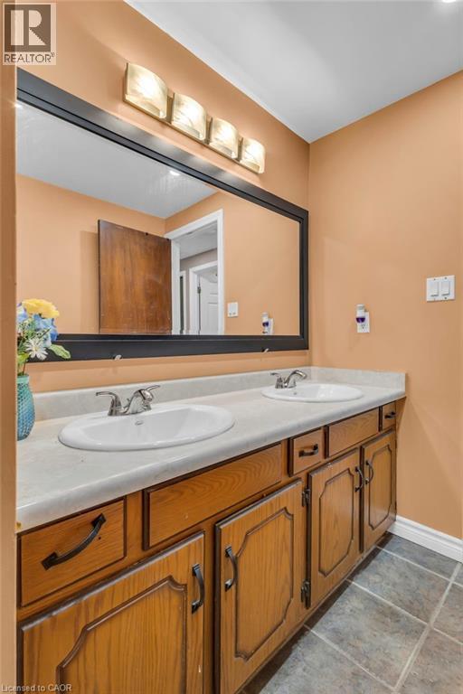 Full bath with double vanity and baseboards - 146 Bechtel Drive, Kitchener, ON - Indoor Photo Showing Bathroom