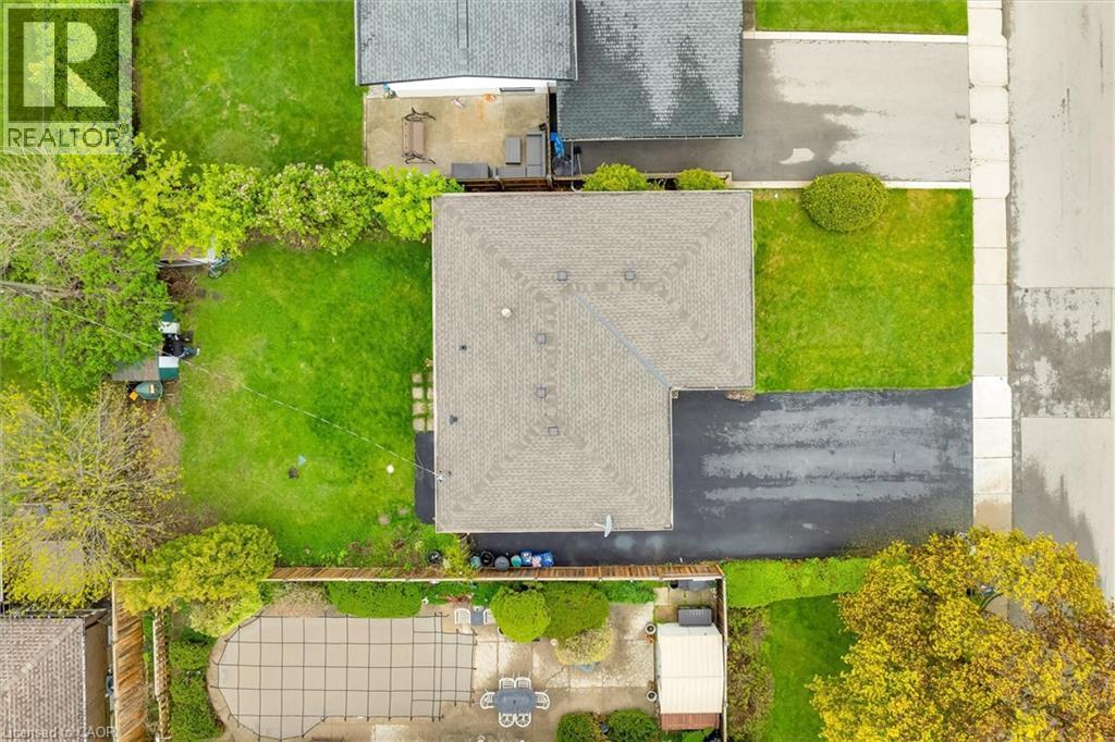 Overhead property view featuring a shingled roof, asphalt driveway, and green lawn - 46 Beaconsfield Drive, Hamilton, ON - Outdoor