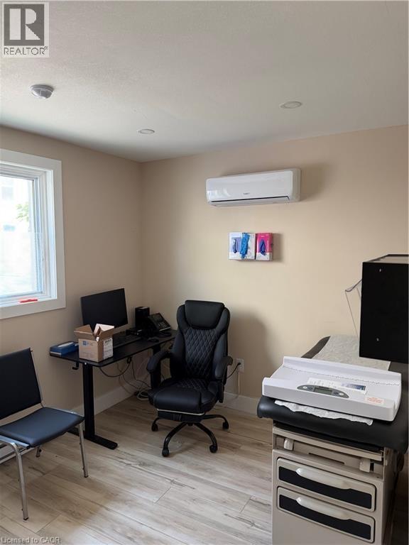 Interior room featuring wood-finish flooring, recessed lighting, and a white window frame - 357 Main Street E Unit# Main Floor, Hamilton, ON