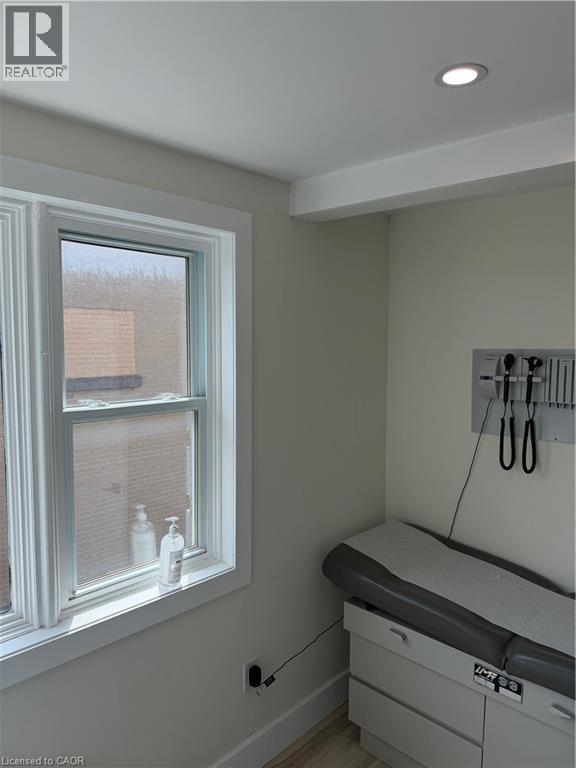 Recessed ceiling lighting illuminates a room with light neutral wall tones and wide window trim - 357 Main Street E Unit# Main Floor, Hamilton, ON