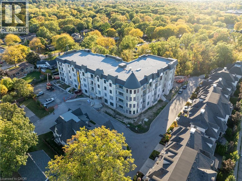Modern multi-story building featuring a distinctive curved facade and multiple balconies - 2 Arbourvale Common Unit# 209, St. Catharines, ON - Outdoor With View