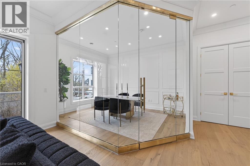 Glass-enclosed room with brass accents, light wood-finish flooring, recessed lighting, and white paneled walls - 2 Arbourvale Common Unit# 209, St. Catharines, ON - Indoor