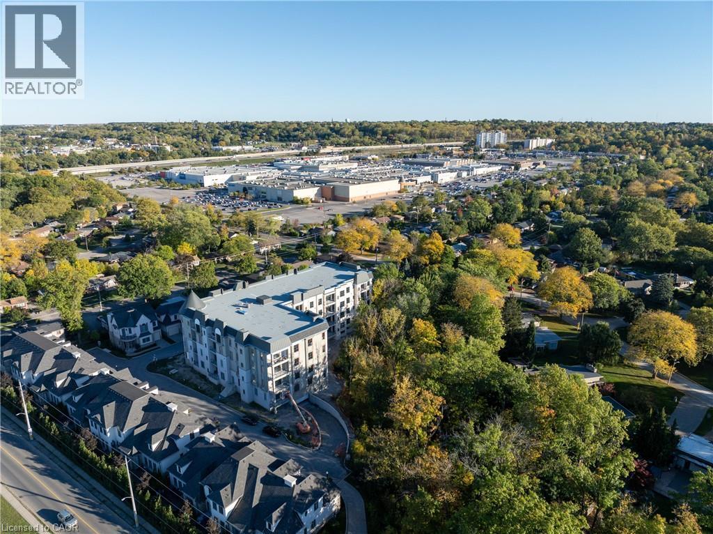Modern multi-story building featuring balconies and a distinctive turret architectural element - 2 Arbourvale Common Unit# 209, St. Catharines, ON - Outdoor With View