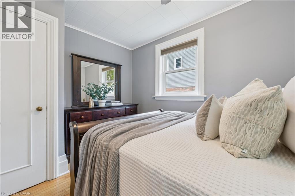 Hardwood flooring contrasting with light gray wall tones - 310 Kitchener Road, Cambridge, ON - Indoor Photo Showing Bedroom