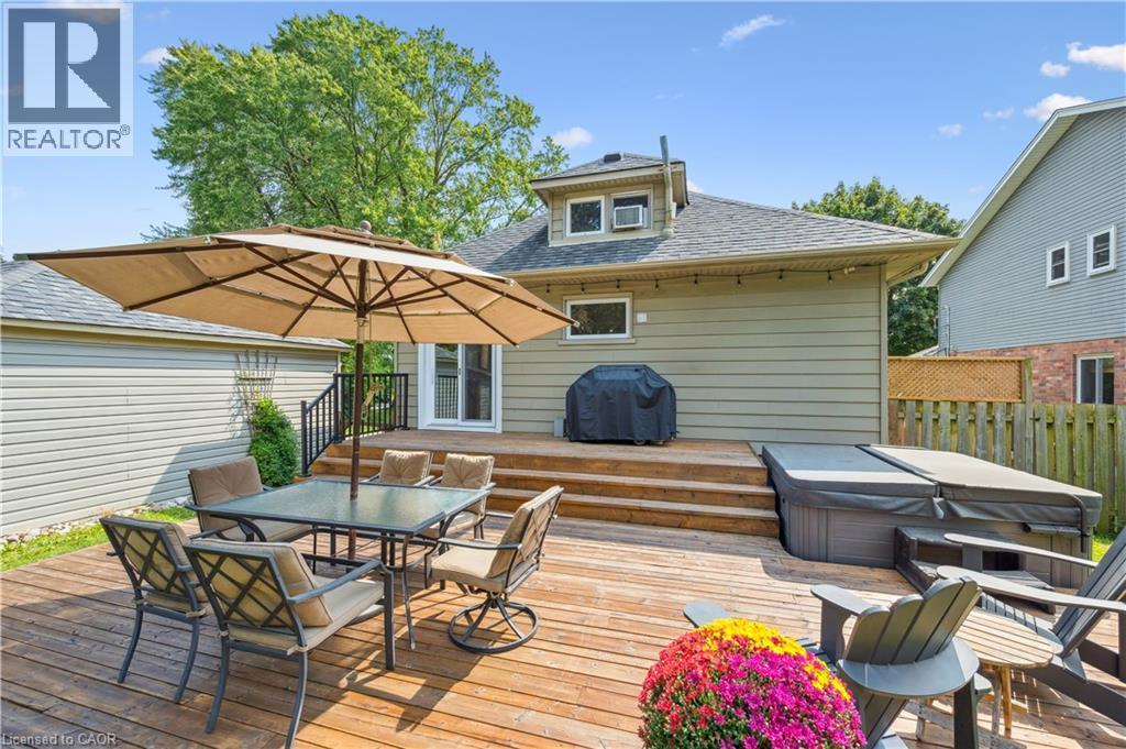 Multi-level wood deck featuring a hot tub, built-in steps, and direct access to the interior - 310 Kitchener Road, Cambridge, ON - Outdoor With Deck Patio Veranda With Exterior