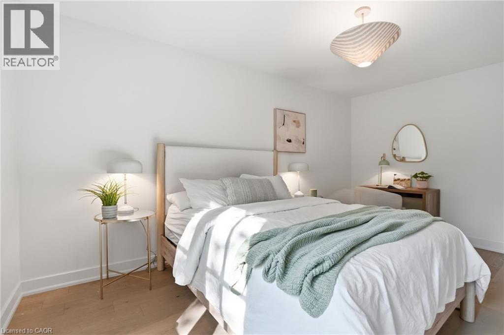 Bedroom featuring light wood-finish flooring, white walls, and a contemporary ceiling fixture - 345 Rankin Drive, Burlington, ON - Indoor Photo Showing Bedroom