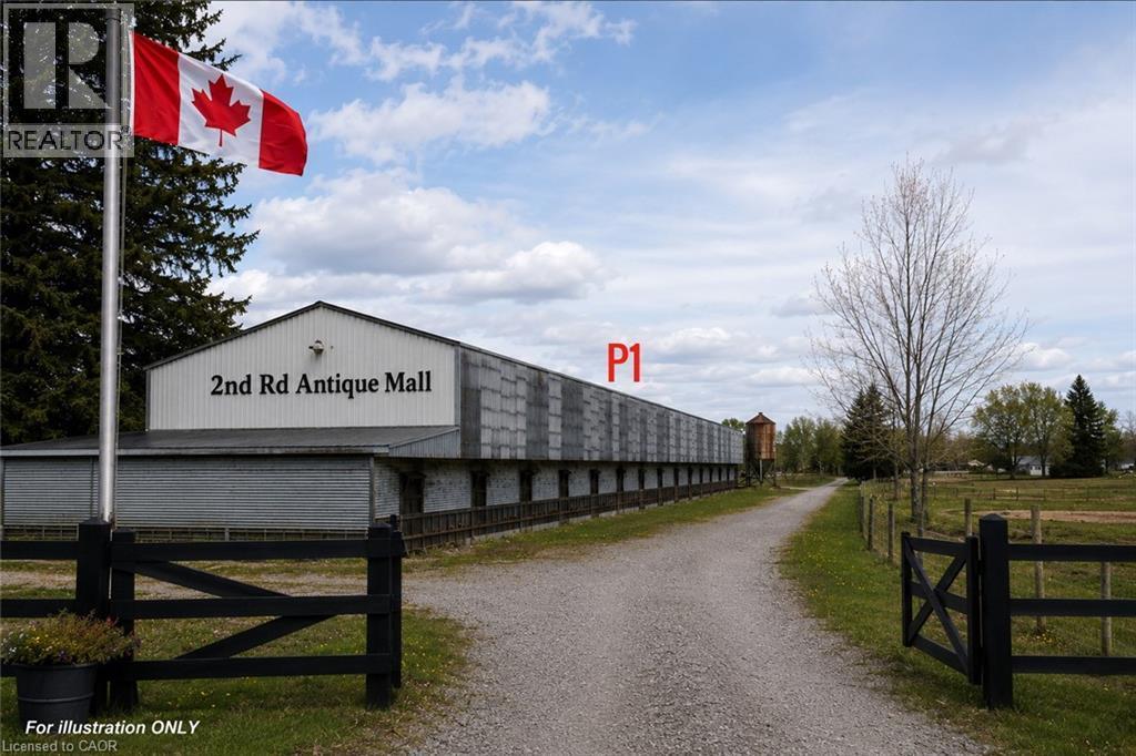 Long commercial building with a white facade and gray siding, featuring a prominent ""2nd Rd Antique Mall"" sign - 96 Second Road E, Stoney Creek, ON - Outdoor