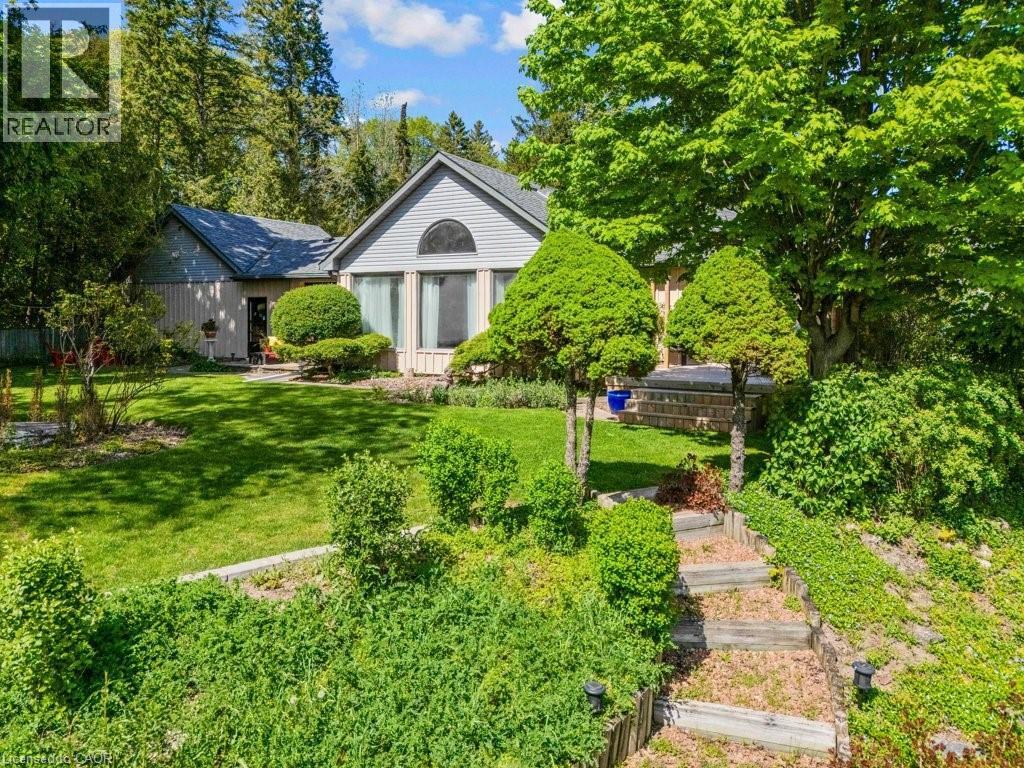 Two-story property featuring a front lawn with established landscaping and mature trees - 91 Limerick Drive, Kitchener, ON - Outdoor