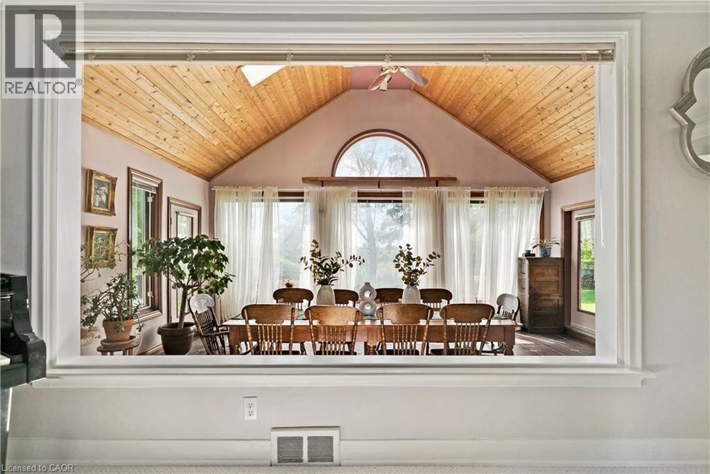 Vaulted wood-paneled ceiling, large arched window, multiple windows with sheer drapery, and wood-finish flooring - 91 Limerick Drive, Kitchener, ON - Indoor Photo Showing Other Room