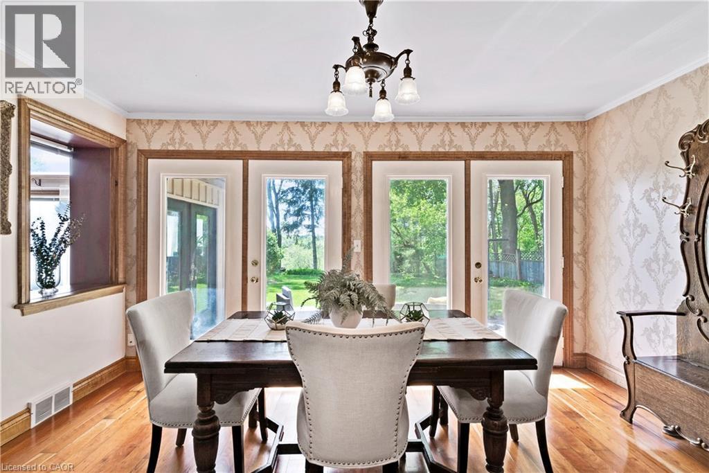 Hardwood flooring complements the patterned wallpaper - 91 Limerick Drive, Kitchener, ON - Indoor Photo Showing Dining Room