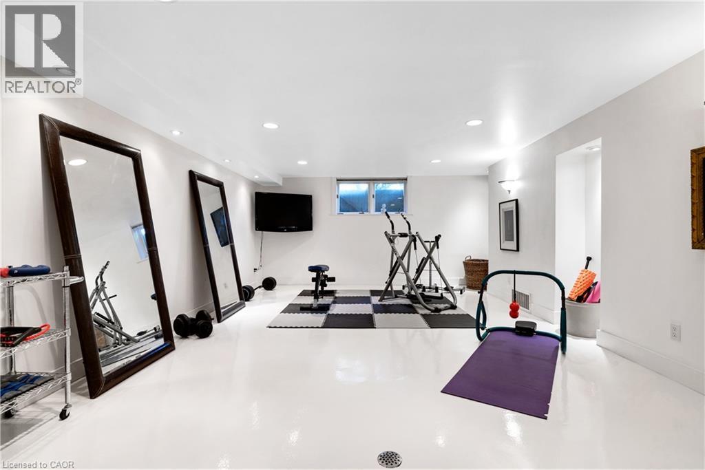 Dedicated fitness area featuring pristine white flooring, recessed lighting, and bright white walls - 91 Limerick Drive, Kitchener, ON - Indoor Photo Showing Gym Room