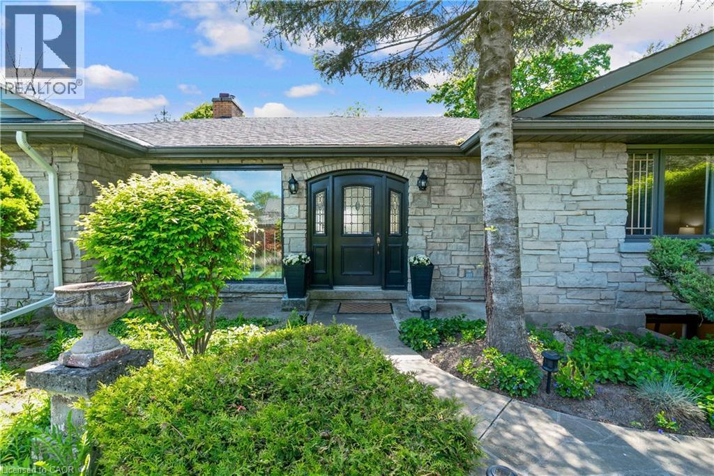 Stone facade entry with a dark double door featuring arched top lites - 91 Limerick Drive, Kitchener, ON - Outdoor