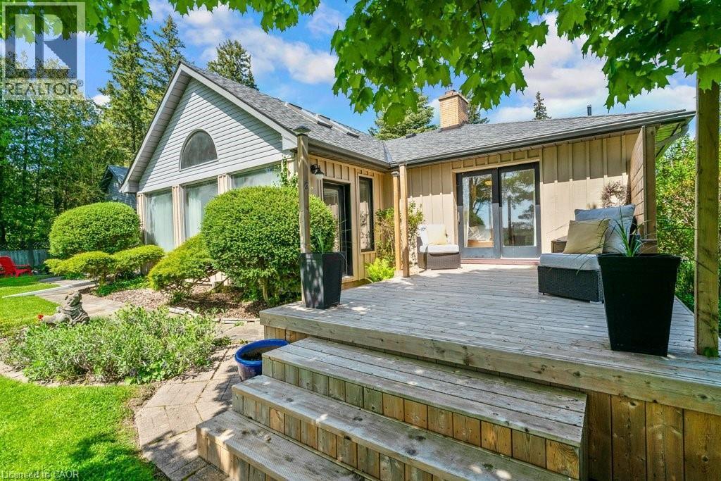 Expansive wood deck with stairs, featuring a light-toned vertical plank exterior and double glass doors - 91 Limerick Drive, Kitchener, ON - Outdoor With Deck Patio Veranda