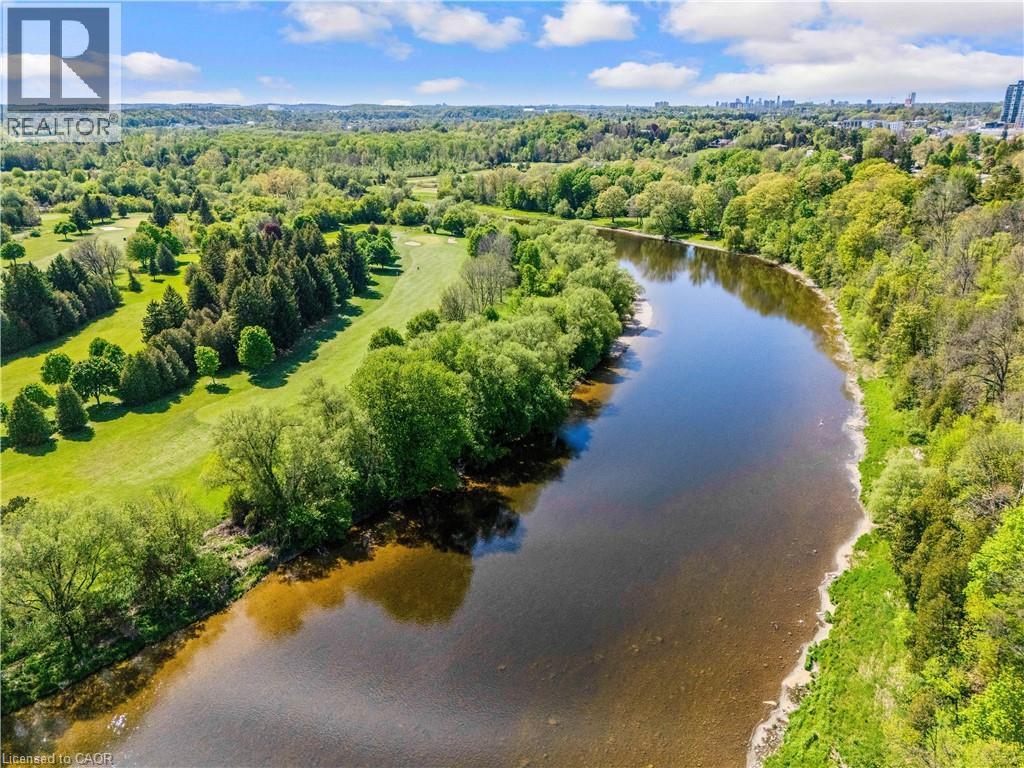 Expansive waterway bordered by lush green foliage and mature trees - 91 Limerick Drive, Kitchener, ON - Outdoor With Body Of Water With View
