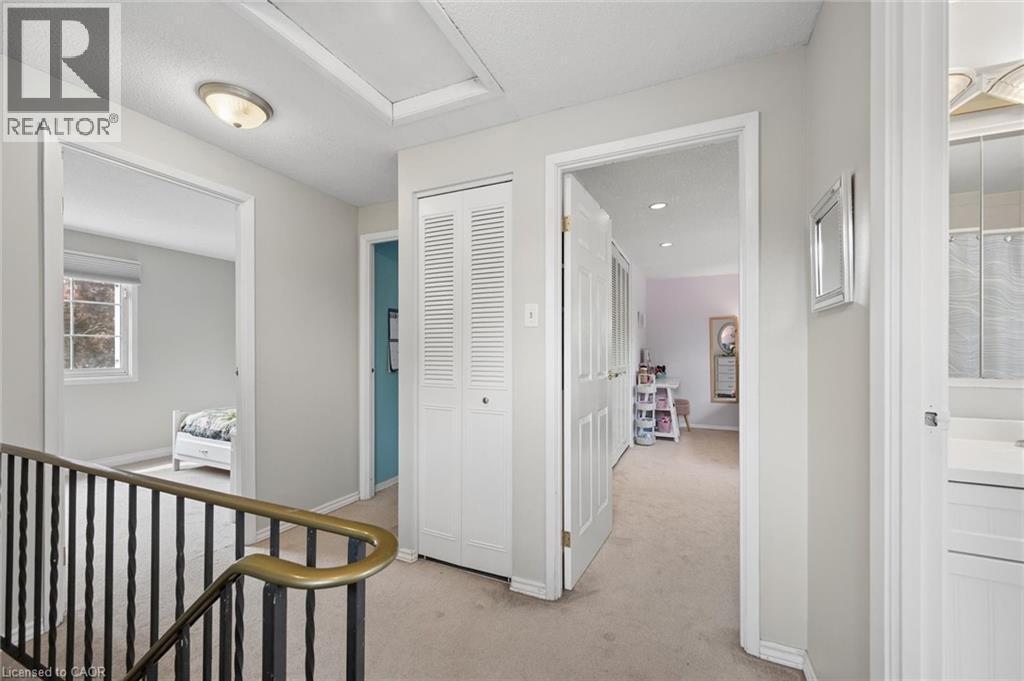 Carpeted hallway with white trim and neutral wall paint - 50 Lewis Crescent, Kitchener, ON - Indoor Photo Showing Other Room