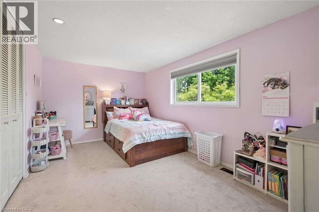 Spacious room featuring light-colored carpeting and a window with exterior tree coverage - 50 Lewis Crescent, Kitchener, ON - Indoor Photo Showing Bedroom