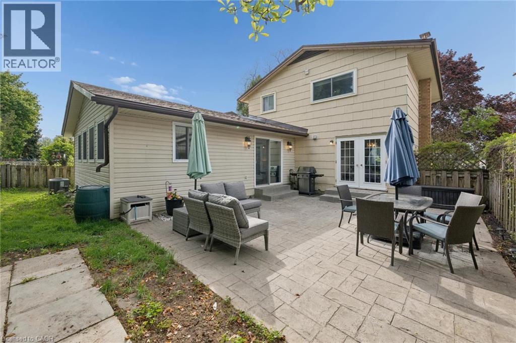 Expansive stamped concrete patio with multiple access points to the home - 50 Lewis Crescent, Kitchener, ON - Outdoor With Deck Patio Veranda With Exterior