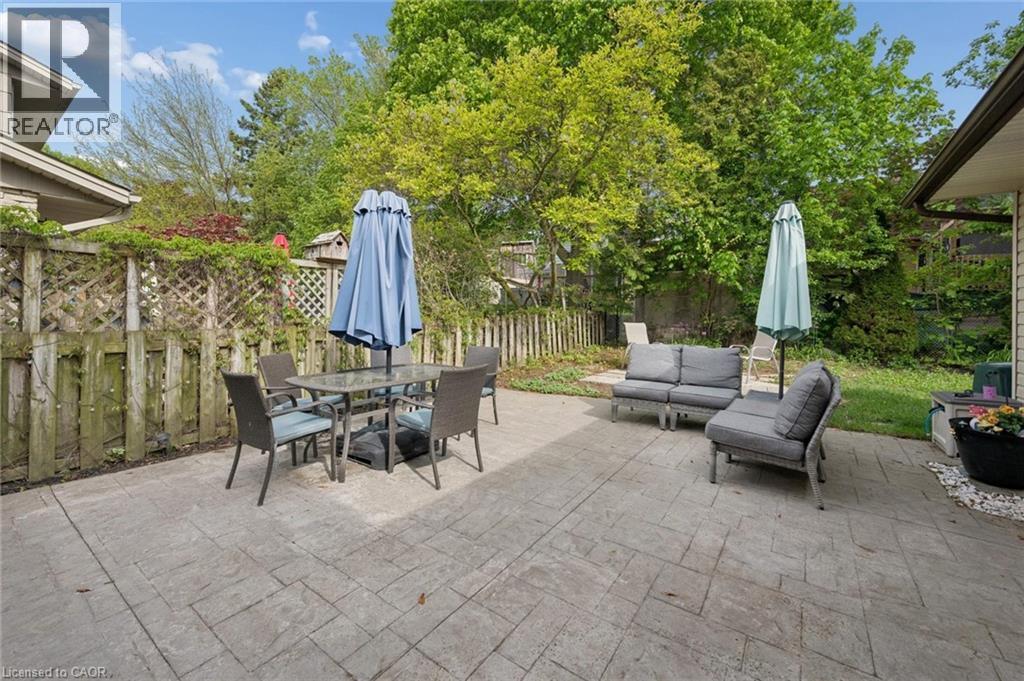 Expansive stamped concrete patio providing ample outdoor living space - 50 Lewis Crescent, Kitchener, ON - Outdoor With Deck Patio Veranda