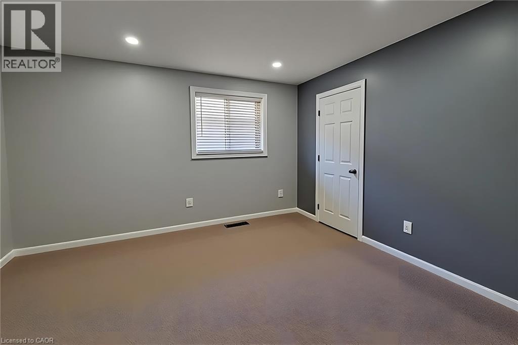 Room featuring neutral tone carpeting and contrasting wall colors - 197 Cloverleaf Drive, Ancaster, ON - Indoor Photo Showing Other Room