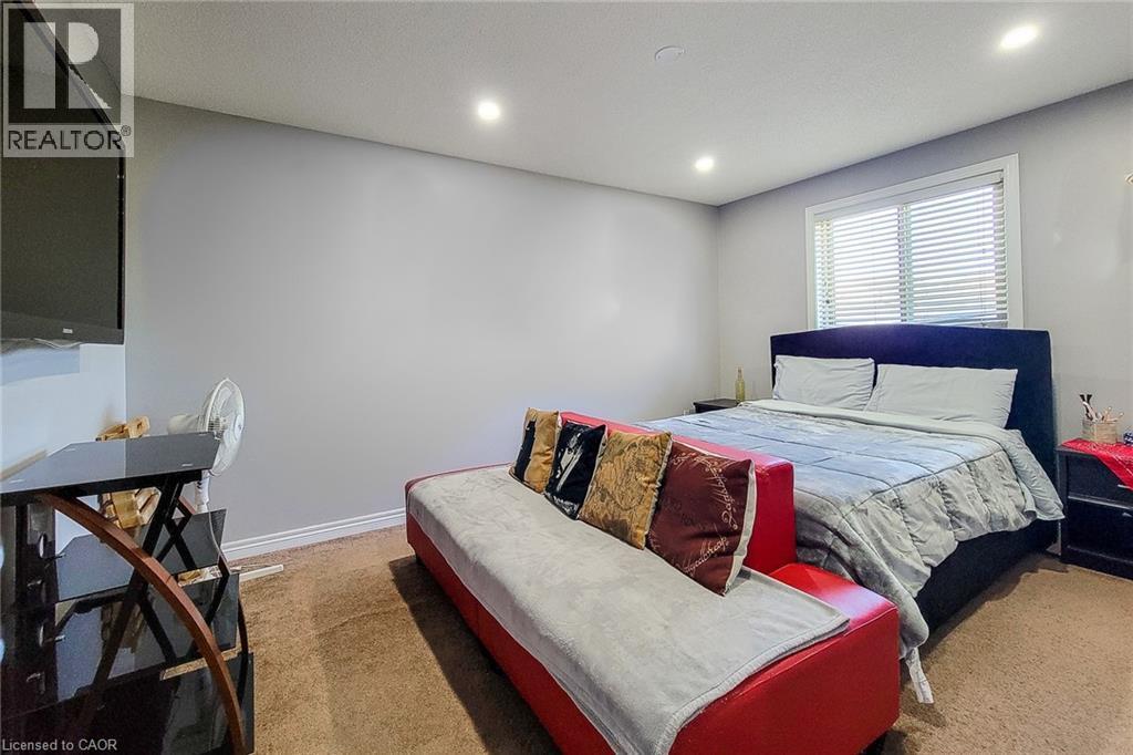 Carpeted room featuring light gray walls, recessed lighting, and a window with blinds - 197 Cloverleaf Drive, Ancaster, ON - Indoor Photo Showing Bedroom