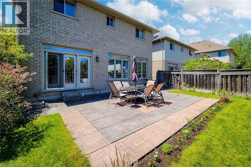 Brick exterior featuring multiple windows and a double glass-paned door - 197 Cloverleaf Drive, Ancaster, ON - Outdoor With Exterior