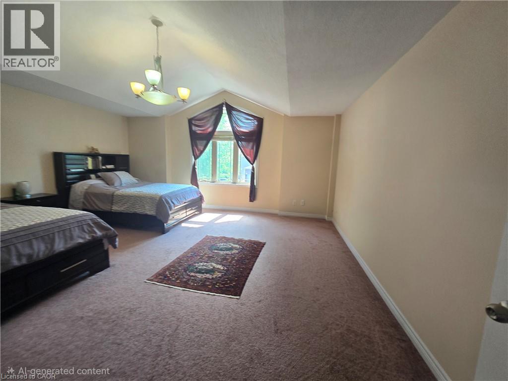 Spacious room featuring vaulted ceilings, a large window, a ceiling-mounted light fixture, and plush carpet flooring - 197 Cloverleaf Drive, Ancaster, ON - Indoor Photo Showing Other Room