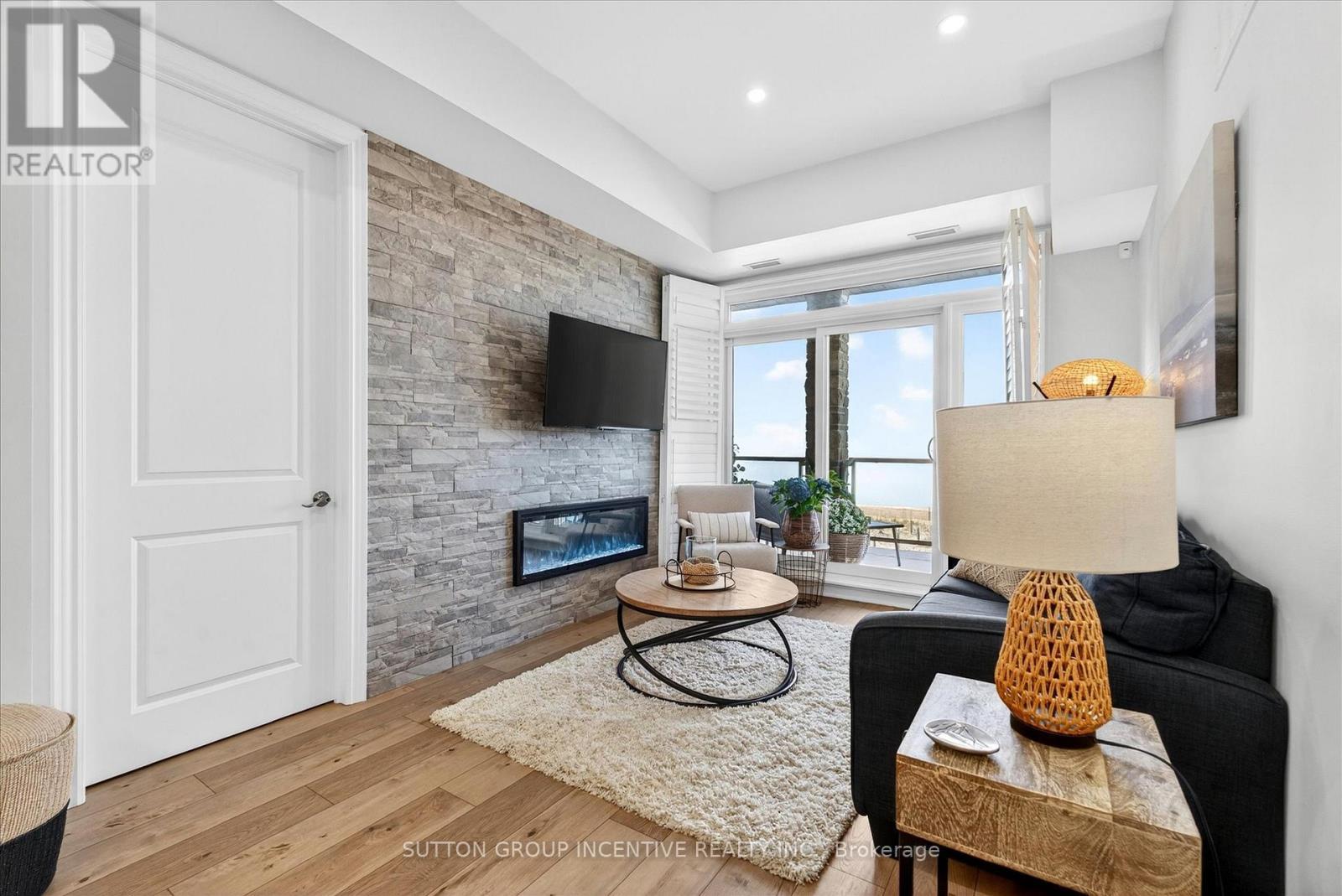Walkout to Balcony - 209 - 764 River Road E, Wasaga Beach, ON - Indoor Photo Showing Living Room With Fireplace