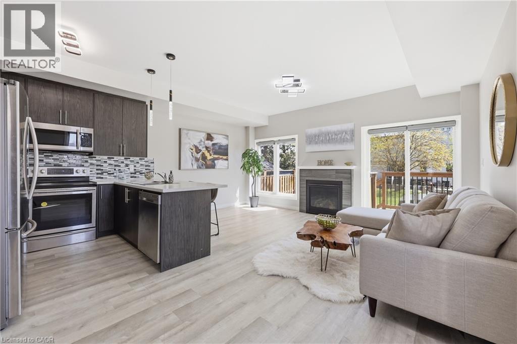 Open-concept living area featuring light wood-finish flooring - 37 Delena Avenue S, Hamilton, ON - Indoor With Fireplace