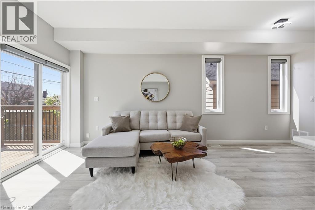 Open-concept living area featuring light wood-finish flooring, light gray walls, and recessed lighting - 37 Delena Avenue S, Hamilton, ON - Indoor Photo Showing Living Room