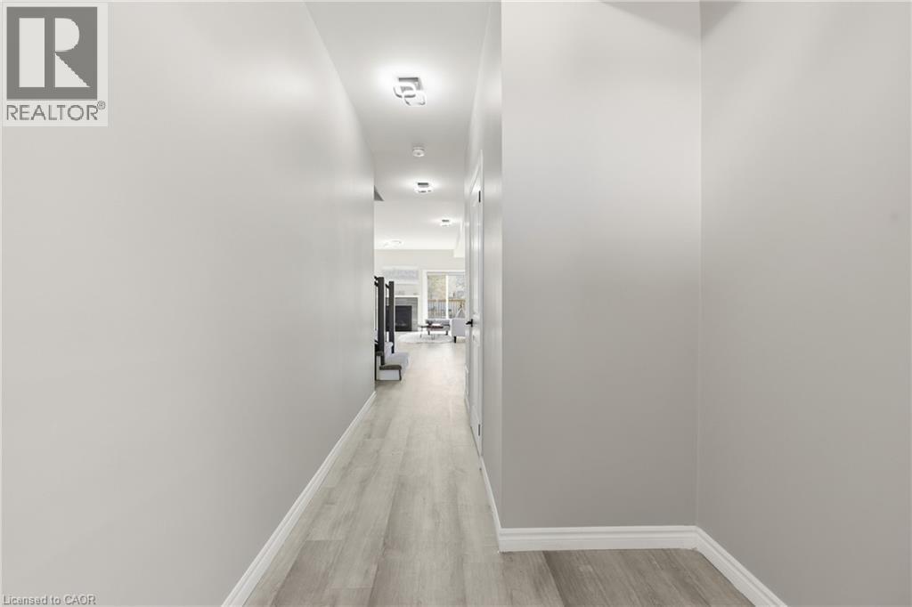 Hallway featuring wood-finish flooring, light grey walls, white baseboards, and recessed ceiling lighting - 37 Delena Avenue S, Hamilton, ON - Indoor Photo Showing Other Room