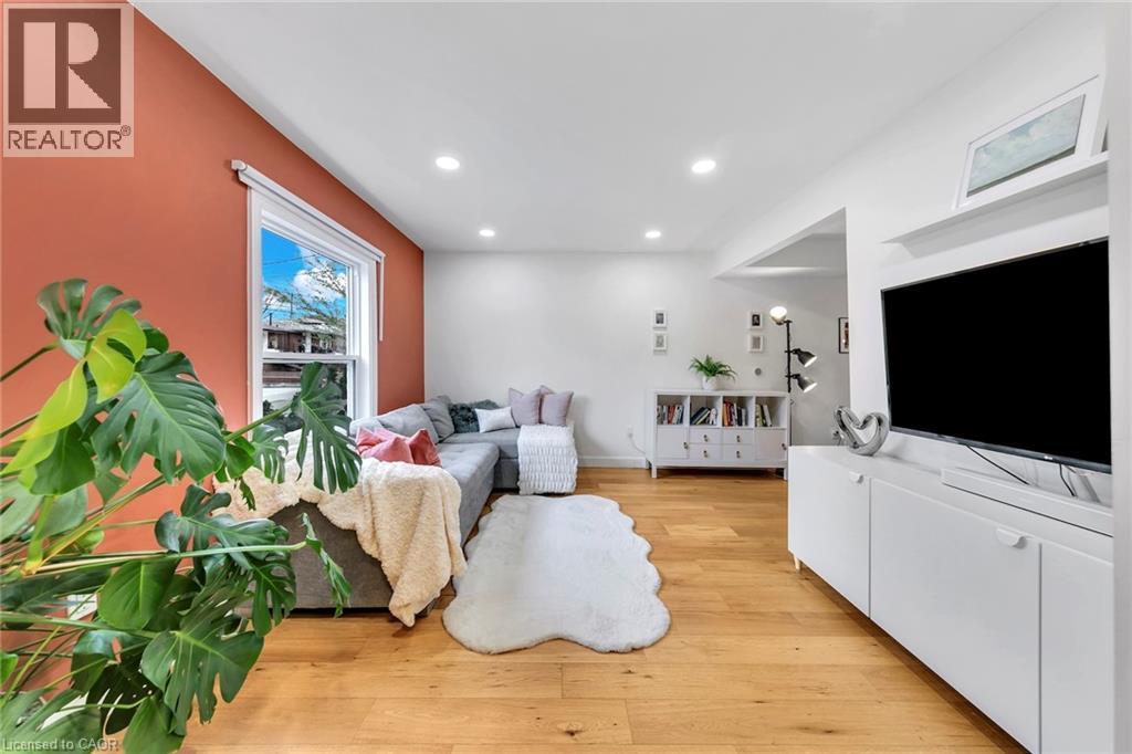 Bright living area featuring wood-finish flooring and recessed lighting - 501 Ferguson Avenue N, Hamilton, ON - Indoor Photo Showing Living Room