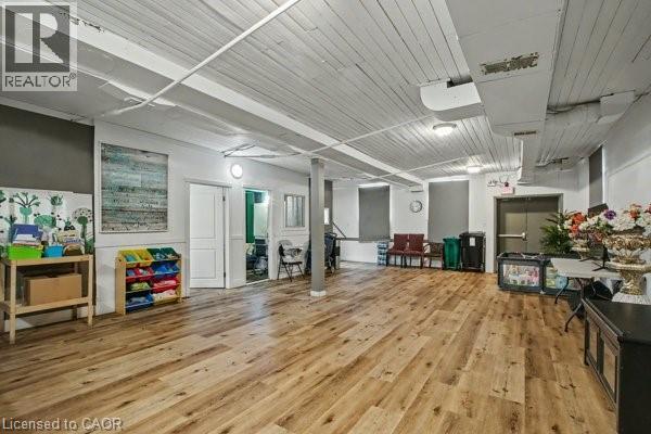Expansive open concept room featuring wood-finish flooring, white plank ceilings, and exposed overhead ductwork - 37 Wellington Street, Cambridge, ON