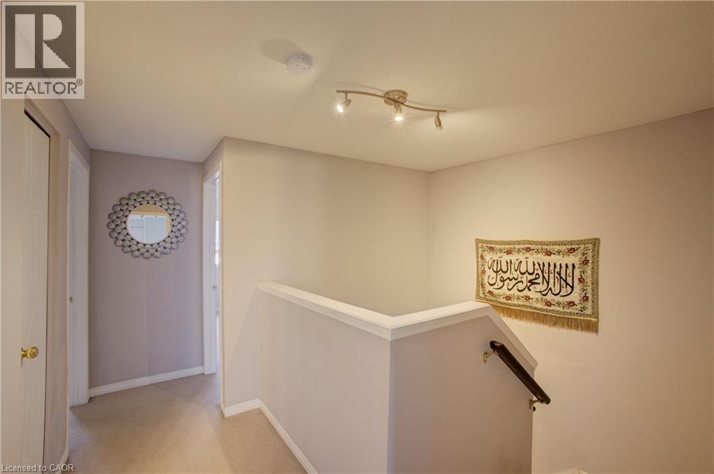 Upper-level landing featuring neutral-toned walls, track lighting, and carpet flooring - 53 Prosperity Drive, Kitchener, ON - Indoor Photo Showing Other Room