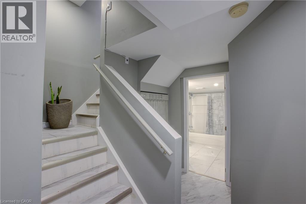 Staircase featuring white risers and marble-finish treads with contrasting trim - 53 Prosperity Drive, Kitchener, ON - Indoor Photo Showing Other Room