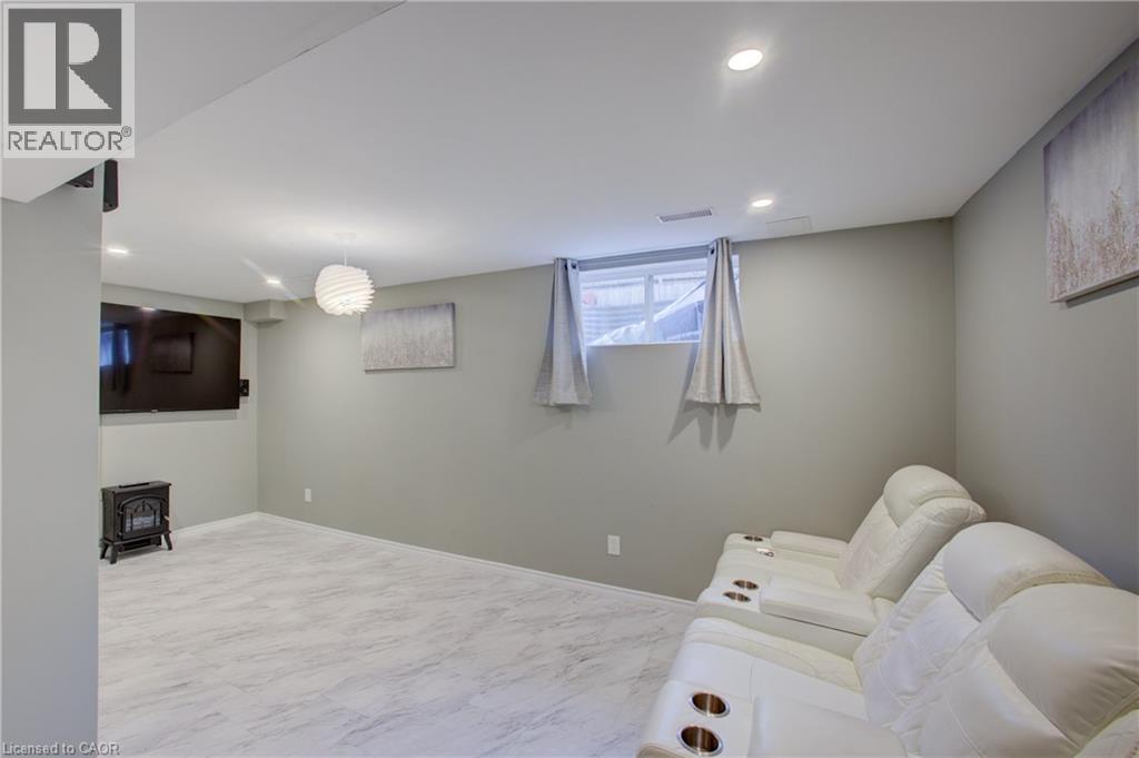 Finished lower level featuring light gray walls and recessed lighting - 53 Prosperity Drive, Kitchener, ON - Indoor