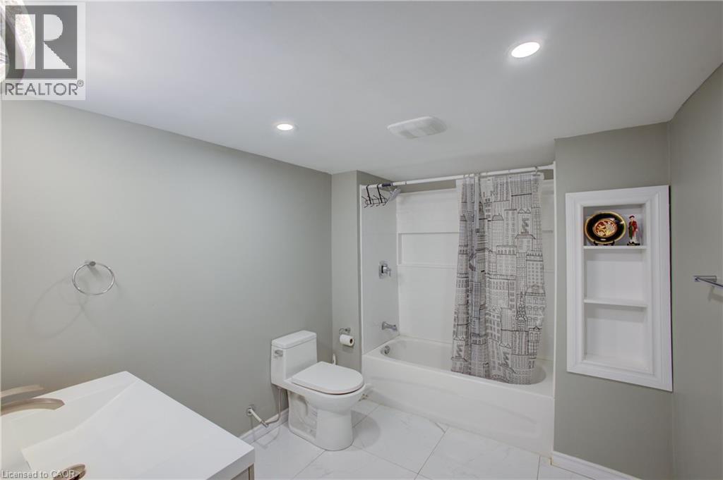 Full bathroom featuring a white vanity with integrated sink, white toilet, and tub with shower - 53 Prosperity Drive, Kitchener, ON - Indoor Photo Showing Bathroom